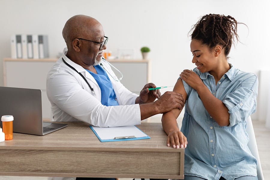 doctor giving shot to a woman